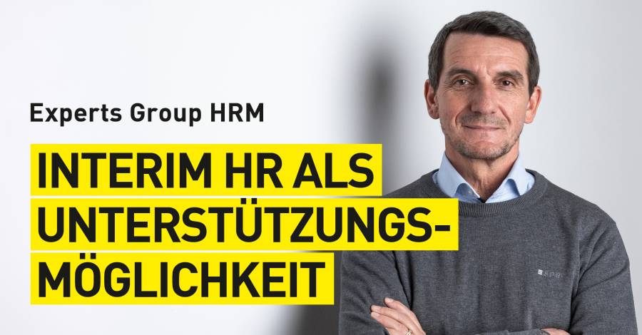HRM-Experte vor weißer Wand mit Schriftzug "Interim HR als Unterstützungsmöglichkeit"
